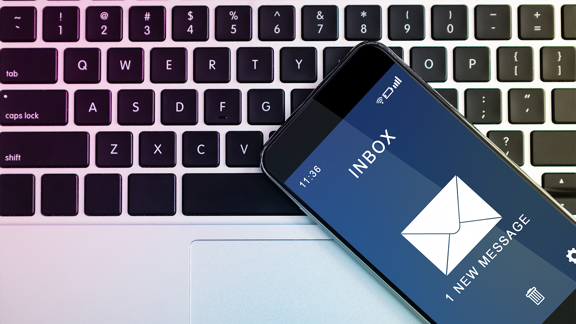 Image of laptop keyboard and iphone